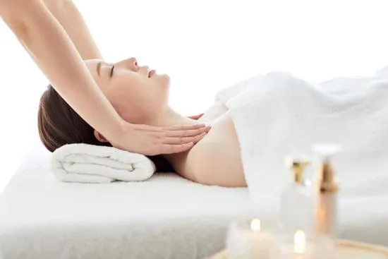 Serene spa setting with a woman receiving a soothing neck massage for ultimate relaxation.