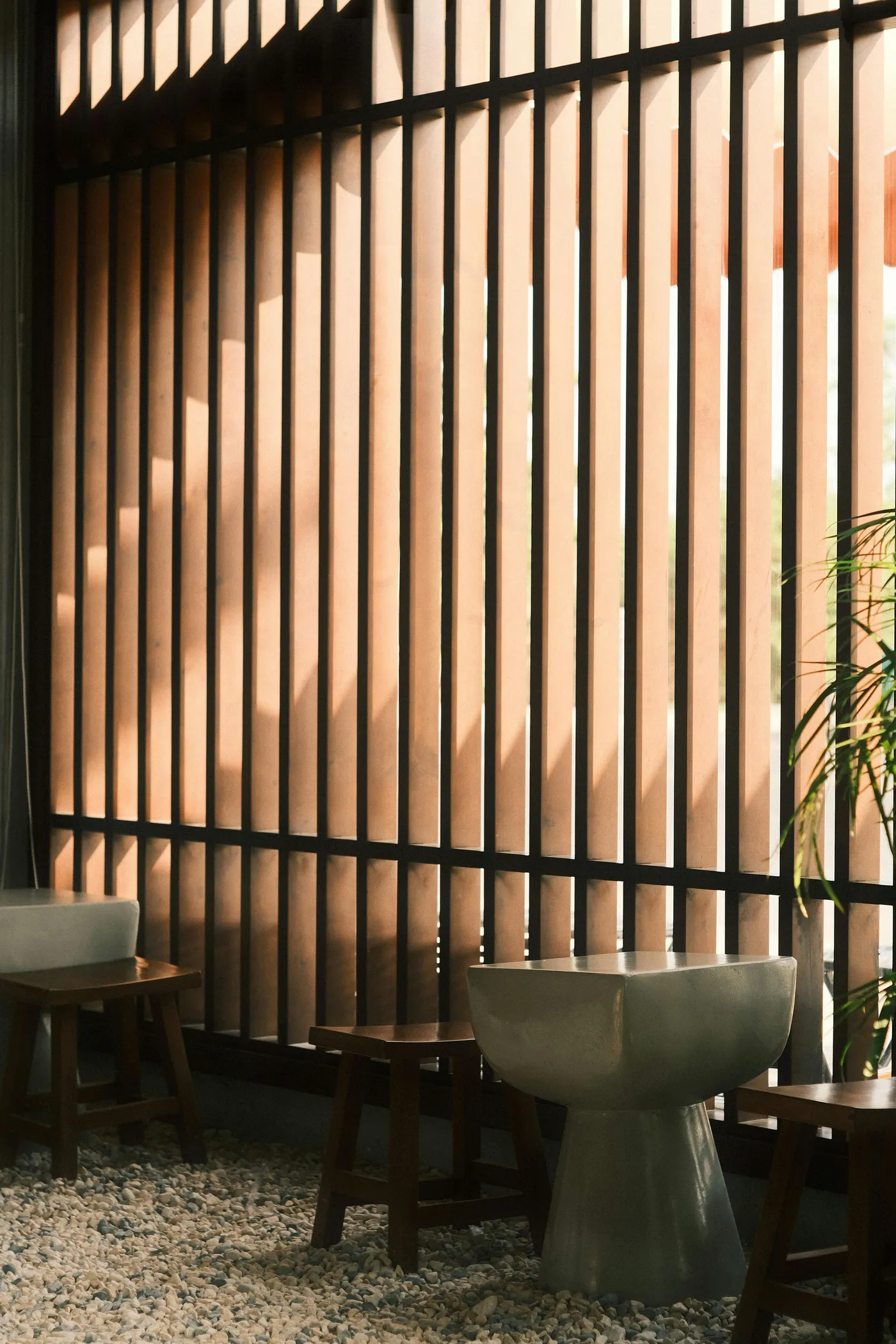 Stylish interior with wooden slat divider and modern seating.